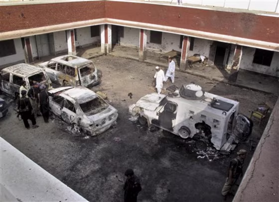 Pakistani police officers examine damaged vehicles, a day after Taliban militants attacked&nbsp; a police station, Sunday, June 26, 2011 in Kolachi near Dera Ismail Khan, Pakistan. The Pakistani Taliban say they used a female suicide bomber for the first time in&nbsp;the attack. 